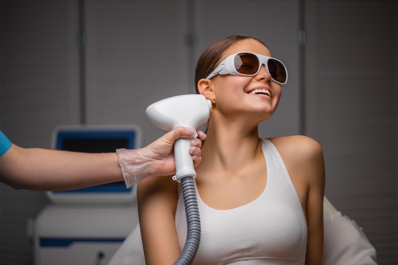 smiling woman came to the procedure of laser hair removal